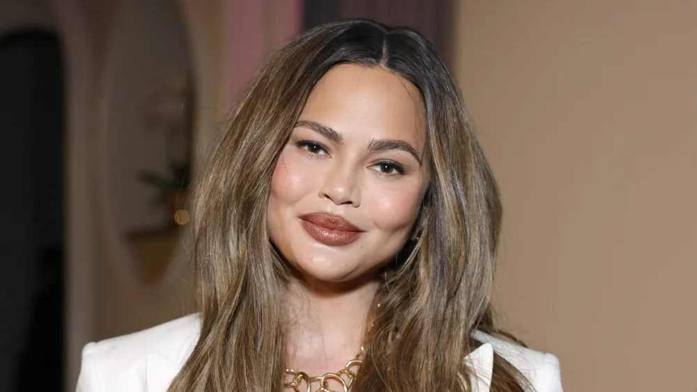 Image for Chrissy Teigen Stepped Out with an $8,900 Woven Tote — and It’s Sparked a Cheaper Lookalike Hunt
